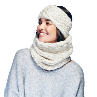 A woman wearing a knitted headband and a Holden Neckwarmer smiles while looking away from the camera.