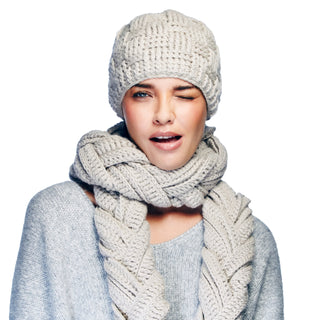 A woman wearing a Shingle Crochet Beanie and scarf.
