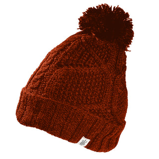 The Cedar Hat is a handmade red wool beanie from Nepal, featuring a large pom-pom on top, folded brim, and a small white side tag.
