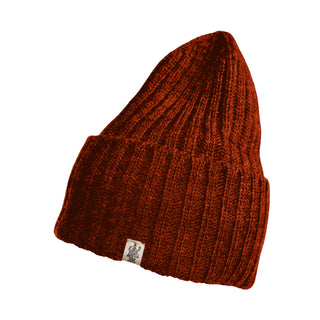 The Cooper Hat is a deep red, hand-knit merino wool winter hat with a textured finish, folded brim, and a small white tag featuring a black illustration on the front. The hat is shown isolated on a white background.