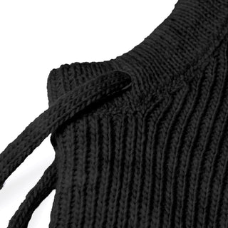 Close-up of the Hand Knit Cozy Hood in black ribbed knit fabric, featuring a thick braided drawstring threaded through the seam; detailed texture and stitching evoke hand knit wool craftsmanship.
