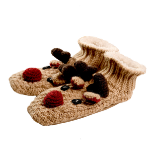 The Reindeer Slippers are hand-knit wool baby booties adorned with reindeer designs. Each cozy winter slipper features a red nose, brown antlers, black eyes, and additional small red and brown decorative details. These soft booties also have a fluffy white inner lining for extra comfort.