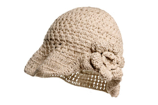 The One Side Turned Up Hat is a beige, crochet-style piece featuring a small brim and a decorative flower on the side. It showcases an intricate lattice pattern and appears to be crafted from soft yarn material. The flower, made from the same yarn, is elegantly attached to the hat's side.