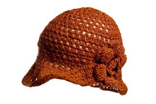 Introducing the One Side Turned Up Hat: a brown crocheted hat showcasing an intricate open-weave pattern adorned with a large, decorative flower on the side. The hat features a small brim that curves slightly upward against a simple white background.