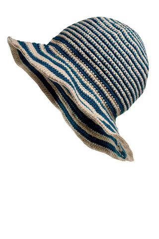 The Stripped Sun Hat, featuring blue and beige stripes, is a knitted design with a wide, slightly wavy brim. It appears slightly tilted and is displayed against a white background.