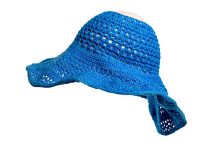 Introducing the Open Top Sun Hat, a charming blue crocheted sun hat featuring a wide brim with an open weave pattern. Its floppy, relaxed shape is perfect for a stylish and comfortable fit. The hat is displayed on an invisible stand or mannequin head to showcase its elegant design.