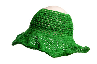 The Open Top Sun Hat, crocheted in green with a wide, slightly flared brim, is displayed against a plain white background. The hat features an open, lacy pattern and is positioned to clearly showcase its texture and shape.