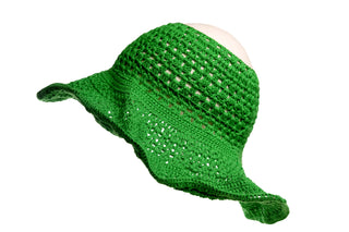 An Open Top Sun Hat with a green crocheted design and floppy brim, showcased against a white background. The hat features an intricate openwork pattern that allows light to pass through.