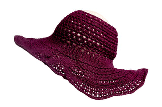 The Open Top Sun Hat is a wide-brimmed, woven accessory in a rich dark red hue, featuring an intricate open-weave design. The slightly floppy brim and soft, lightweight texture of the hat enhance its relaxed aesthetic. It is showcased against a plain white background.