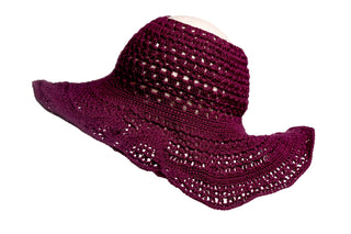 An Open Top Sun Hat in burgundy with a wide brim and open weave pattern is displayed against a white background, featuring wavy edges around the brim.