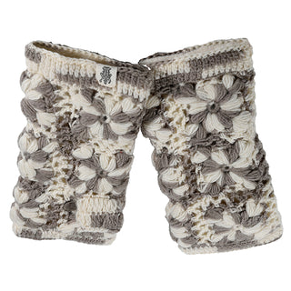 The Multi Color Flower Crochet Handwarmers feature cream, white, and gray yarn with a raised floral pattern and a logo tag on one glove, shown against a crisp white background.