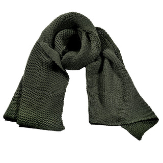 The Ithaca Scarf, in dark green, is displayed with a loose central knot that highlights its textured knit and soft, thick fabric. Featuring pointed ends, this cozy accessory offers both warmth and style.