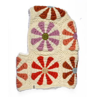 Introducing the Hand Crochet Petal Hood: a hand-crafted piece with an irregular, angular silhouette and softly rounded edges. This hood features a cream background adorned with flower motifs in orange, red, and lavender—reminiscent of classic crochet daisies—arranged in a tidy grid pattern.
