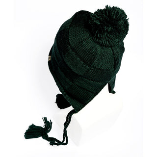 A Hand Knit Nest Hat in dark green wool, featuring earflaps, a pom-pom on top, and braided tassels, is shown on a white mannequin head against a white background. This sherpa-lined hat offers both warmth and style for chilly winter days.