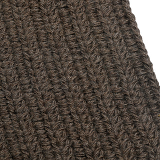 Close-up of a dark brown, ribbed crochet fabric with a textured pattern, likely from the Hand Crochet Velour Scarf. The yarn fibers are clearly visible, with the rows running diagonally across the image. The background is white and partially visible at the edge.