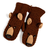 A pair of Hand Crochet Grizzly Mittens, crafted from wool and designed to look like brown bear faces with beige snouts, black nostrils, embroidered eyes, and attached knit ears on each mitten. These charming kids’ mittens are shown on a white background.
