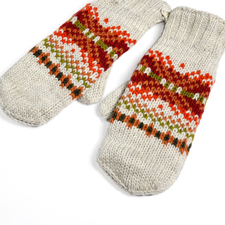 A pair of Hand Knit Explore Mittens featuring a Fair Isle pattern in red, orange, green, and brown on a beige background, displayed on a white surface.