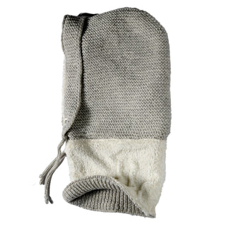 A Hand Knit Glide Hood in gray, featuring a seed-stitch knit pattern, drawstring closure, and white fleece lining, is laid flat on a white background.