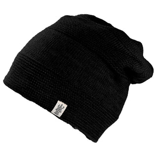 The Edgar Slouch is a black wool beanie with a textured knit pattern and a small rectangular label on the brim, handmade in Nepal and shown against a plain white background.
