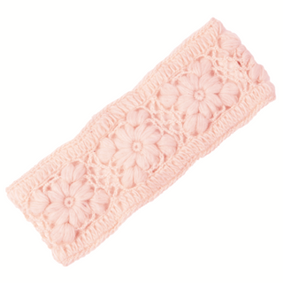 The Flower Crochet Headband- SOLIDS is a knitted pink headband adorned with large, floral motifs. Crafted from wool, it boasts an intricate woven design with a visibly textured surface and soft pastel color. This rectangular headband features slightly scalloped edges.