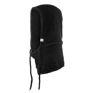 The Hand Loom Hero Hood is a black knitted Merino wool hood with an attached face covering and two front drawstrings, shown from a side angle on a white background—a perfect winter accessory.