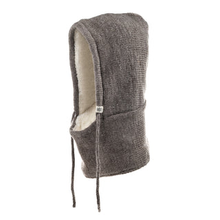 The Hand Loom Hero Hood is a knit gray Merino wool hood with a soft beige lining, front pocket, and two drawstrings. This cozy winter wear is shown against a plain white background.