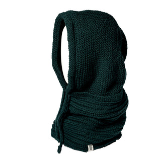 A dark green Hand Knit Halo Reverse Hood, featuring a chunky knit design with wide armholes, a large draped front pocket, a cozy hand-knit hood, and a label at the bottom, is displayed against a white background.