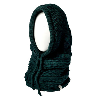 A Hand Knit Halo Reverse Hood in dark green is showcased on a white mannequin head. Featuring thick ribbed material with a drawstring at the neck, the hood and neck warmer has its tag visible near the bottom. The background is plain white.