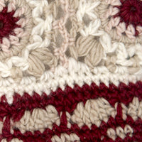 Close-up of Dreams Hand Crochet Handwarmers, handmade in Nepal with cream, beige, and burgundy yarn. Textured patterns and visible stitches highlight the intricate design and craftsmanship.