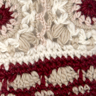 Close-up of Dreams Hand Crochet Handwarmers, handmade in Nepal with cream, beige, and burgundy yarn. Textured patterns and visible stitches highlight the intricate design and craftsmanship.