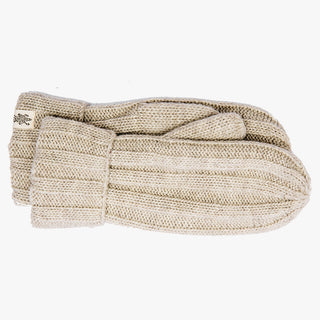 A pair of Ribbed Mittens, crafted from beige wool and handmade in Nepal, lay flat on a plain white background. The wrist cuffs are folded back, revealing a small embroidered label on the left mitten.