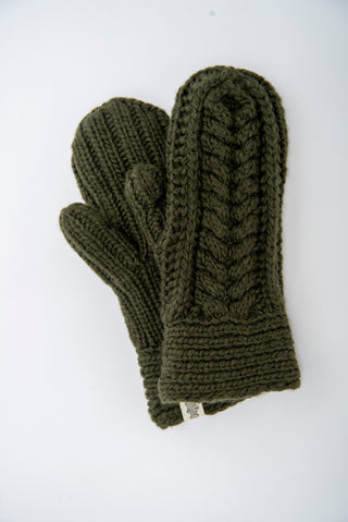 The Soho Mittens are hand-knit in dark green Merino wool with a cable pattern, shown on a white background—perfect cozy mittens for women.