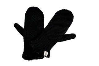 The Kent Mittens, handmade in Nepal from black wool, are shown on a white background. One mitten slightly overlaps the other, displaying a small white tag on the cuff of the bottom mitten.