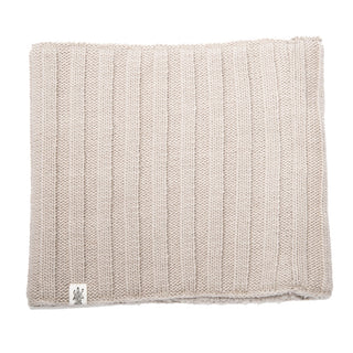 A Ribbed Neckwarmer is showcased, featuring a square, beige design with vertical ribbed patterns. A small white tag with a logo is attached to one corner of the tightly woven wool, providing a cozy and textured appearance.