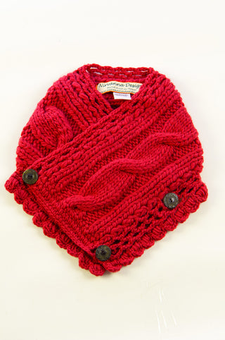 A soft wool rib knit pretty neck warmer with a cable pattern and button embellishments laid flat against a light background.