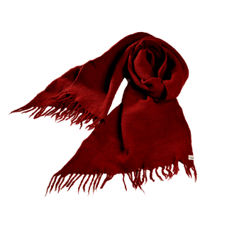 The Merino Fringe Scarf, in a vibrant red hue and featuring fringed edges, is displayed in a neat, flowing manner. Made with 100% merino wool and handmade in Nepal, the fabric appears soft and slightly textured. A small label is visible at one end, while the evenly spaced fringes add a decorative touch to this exquisite accessory.