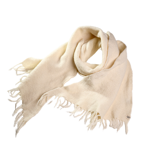 Introducing the Merino Fringe Scarf, meticulously handmade in Nepal using 100% merino wool. This luxurious light beige scarf offers both softness and warmth while featuring chic fringe detailing on both ends for a casual yet stylish appearance.