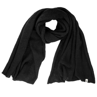 The Hand Loom Air Wrap Scarf, loosely knit in black, is shown laid flat on a white background with one end folded over and a small white tag at the lower right corner.