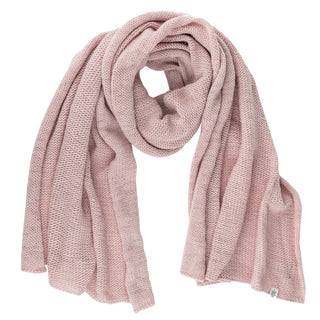 The Hand Loom Air Wrap Scarf, in light pink merino wool, is displayed on a white background. It looks soft, cozy, and thick with folded loose ends and a small tag attached to one end.