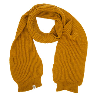 A mustard yellow Hand Loom Laurent Scarf, handmade in Nepal from merino wool with a ribbed texture, is laid flat on a white background. A small white tag is attached to one end.