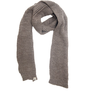 A long, knitted brown Hand Loom Laurent Scarf with a ribbed texture is laid flat on a white background, handmade in Nepal and finished with a small rectangular tag on one end.