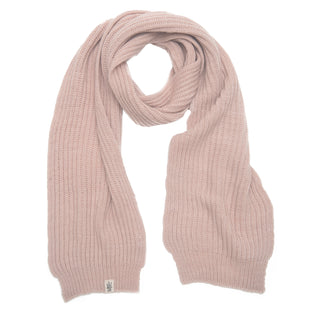 A Hand Loom Laurent Scarf in pale pink merino wool is laid flat on a white background, featuring a ribbed texture, a small sewn-on tag near one end, and is handmade in Nepal.