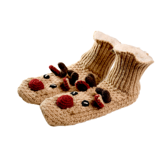 The Reindeer Slippers are a pair of hand-knit wool slippers designed in the shape of reindeer. Each slipper is beige and features a red nose, black eyes, and small antlers on top, perfectly resembling a reindeer. The interior is lined with a fuzzy, white material to provide extra warmth on chilly evenings.