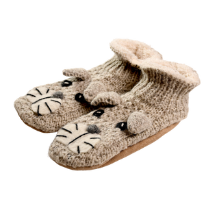 A pair of children's grey woolen slippers designed to look like mice, the Shmil The Cat Slippers are adorned with black embroidered eyes, ears, and whiskers on the front, along with beige felt detailing for the nose and inner ears. The soles are crafted from a soft fabric material.