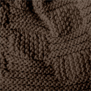 Close-up view of the Hand Knit Sena Hat, showcasing its textured zigzag pattern. The thick yarn and skilled knitting technique create a raised design across the surface, while the lighting highlights the fabric’s intricate texture and detail.