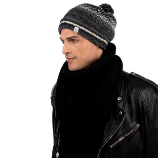 A man in a black jacket and a handmade merino wool Air Wrap Scarf.