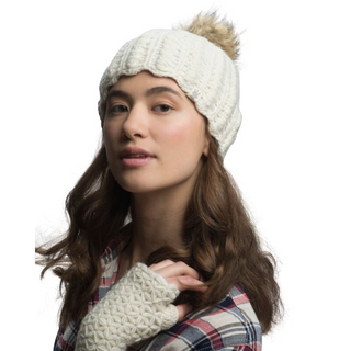 A woman with long brown hair wearing a white Layla beanie handmade in Nepal merino wool with a pompom and matching mittens.