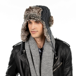 A man wearing a Cable Knit Russian Hat w/ Faux Fur and scarf.