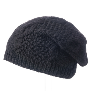 A handmade black wool sectional slouch hat on a stand.