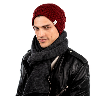 A man wearing a Wave Slouch made from organic cotton and a leather jacket.